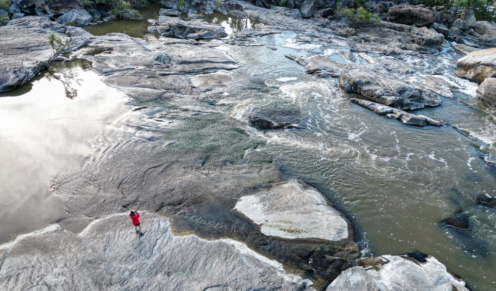 A person taking a photograph at the gorge along Slippery Rock walking track in Kwiambal National Park. Photo &copy; DPE