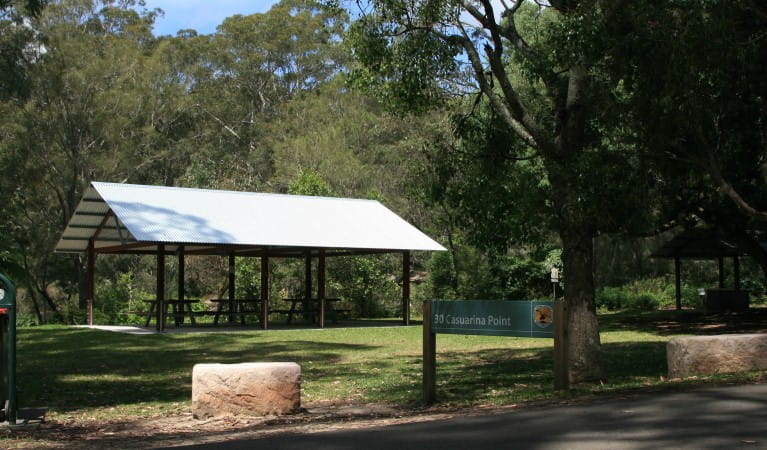 A picnic shelter and a sign at Casuarina Point picnic area in Lane Cove National Park. Photo: Nathan Askey-Doran &copy; DPIE