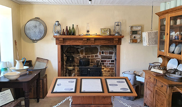 The western interior of Jenkins Kitchen with crockery and fireplace on display in Lane Cove National Park. Photo: Ryan Siddons &copy; DPIE