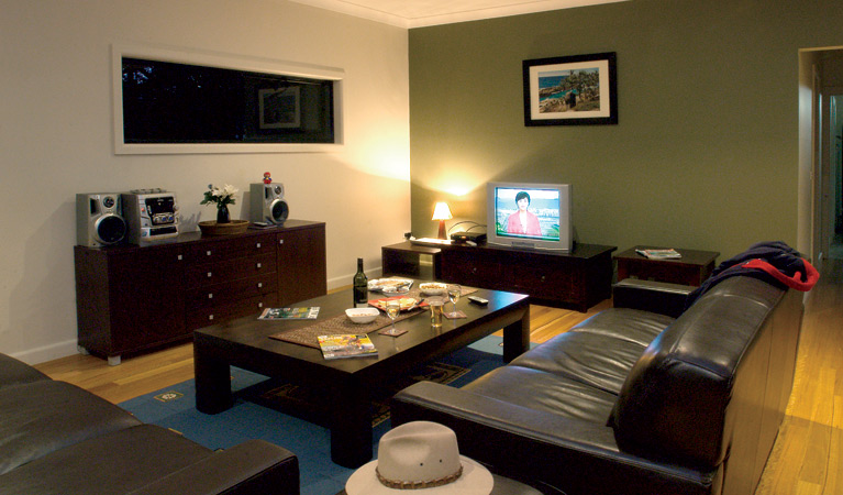 The common room area, Plomer Beach House, Limeburners Creek National Park. Photo: Michael van Ewijk/OEH