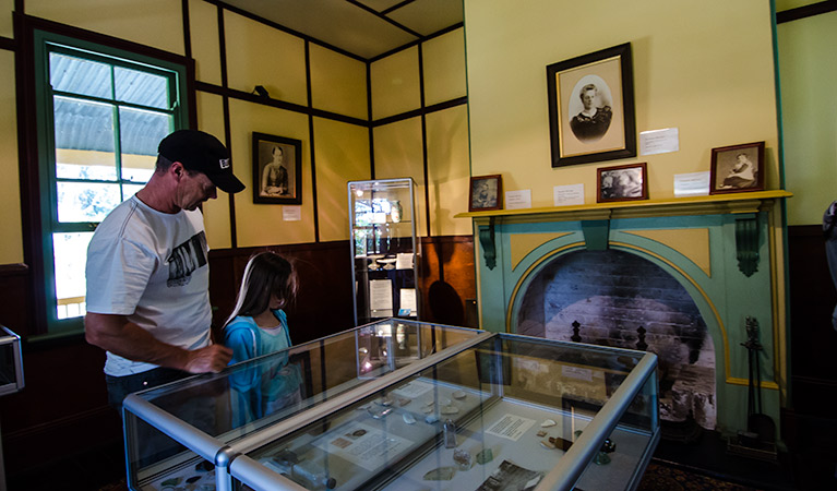Visitors look at artefacts in a glass cabinet in Roto House, Roto House Historic Site. Photo: John Spencer/NSW Government