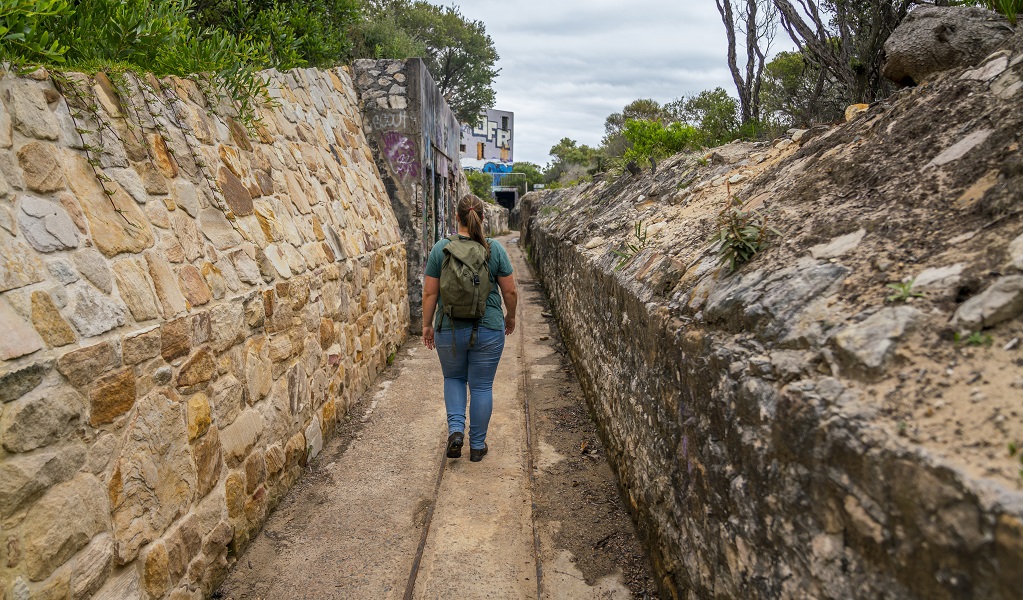 Person walking through the stone embankment on Artillery track. Photo: John  Spencer &copy; DPE