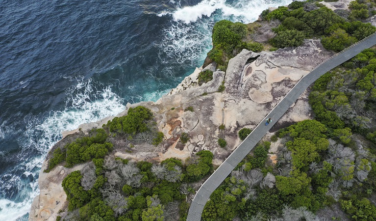 Aerial of cliffs, ocean and walking track boardwalk in Malabar Headland National Park. Photo: John Spencer &copy; DPE