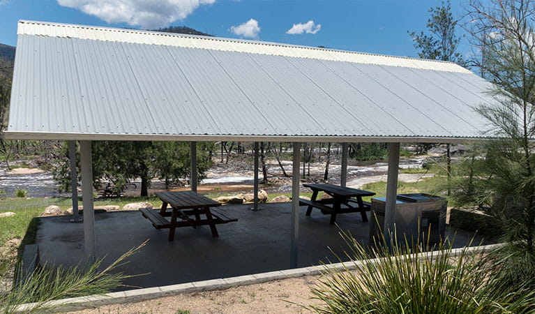 A shelter with picnic tables and a barbecue at Mann River campground and picnic area in Mann River Nature Reserve. Photo: Leah Pippos &copy; DPE