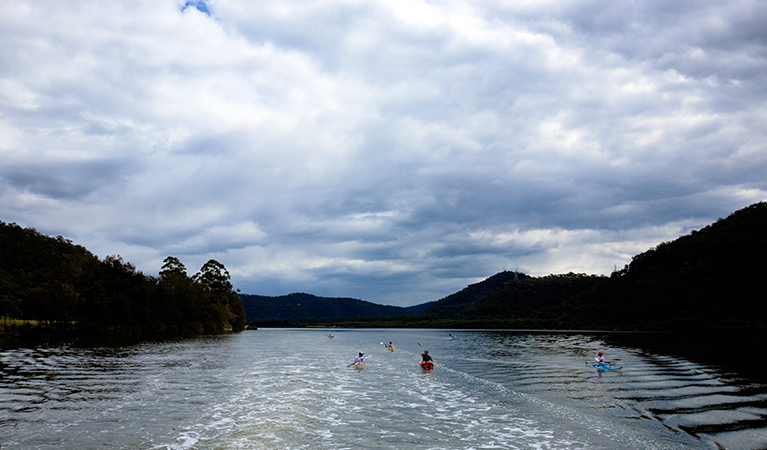 A group of kayakers on the Hawkesbury River on a cloudy day. Photo: Rosie Nicolai/DPIE.