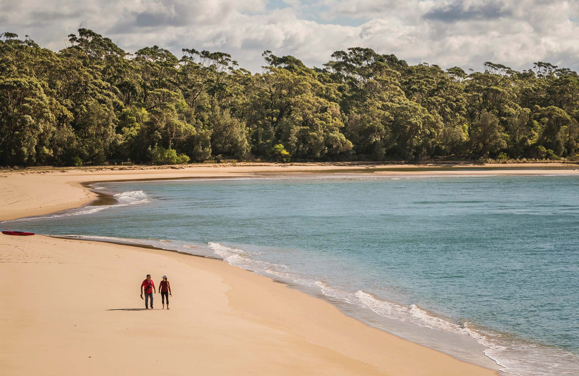2 people walking on beach at Bithry Inlet. Photo: John Spencer/DPIE