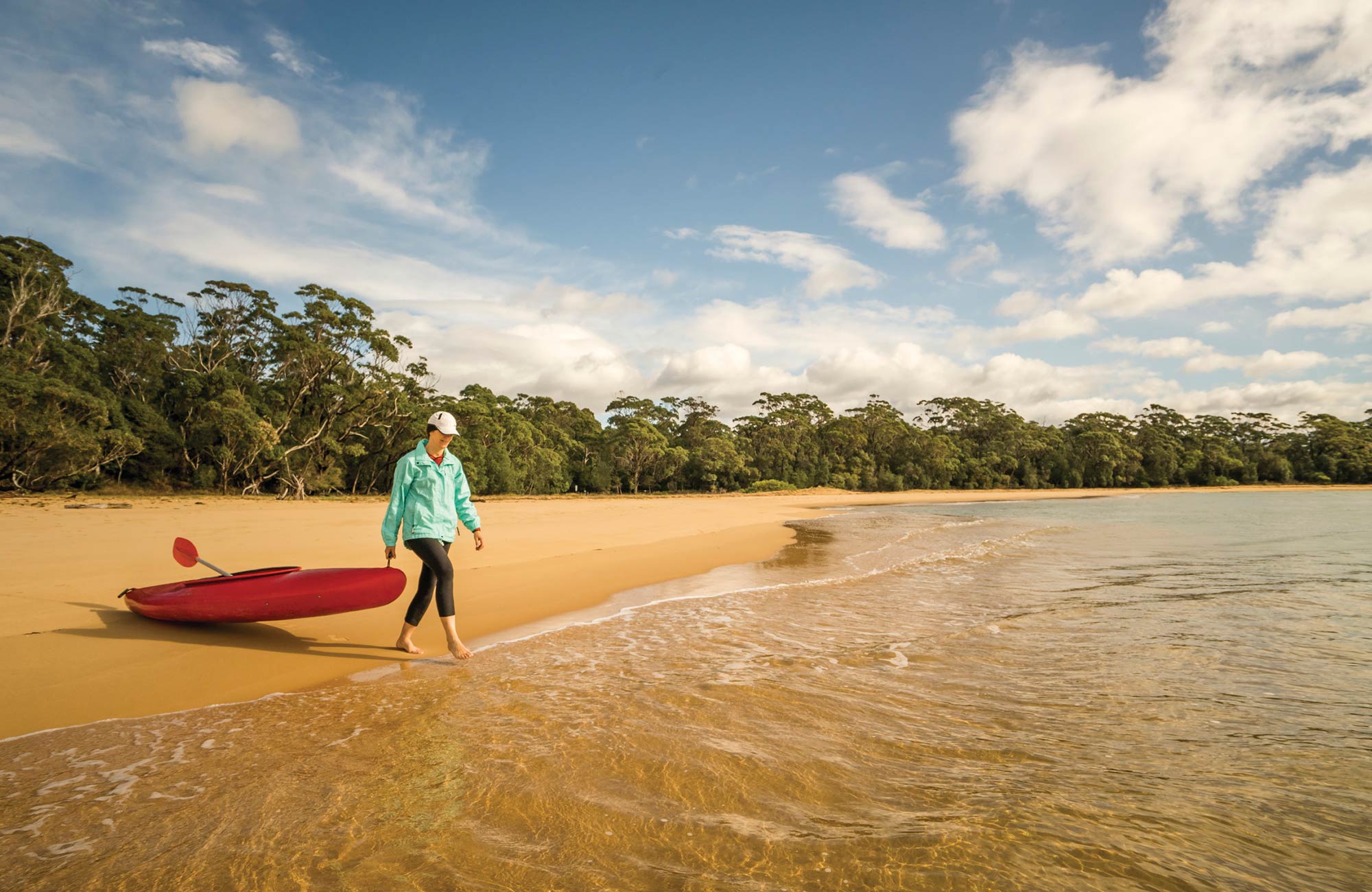 Woman with kayak at Bithry Inlet. Photo: John Spencer/DPIE