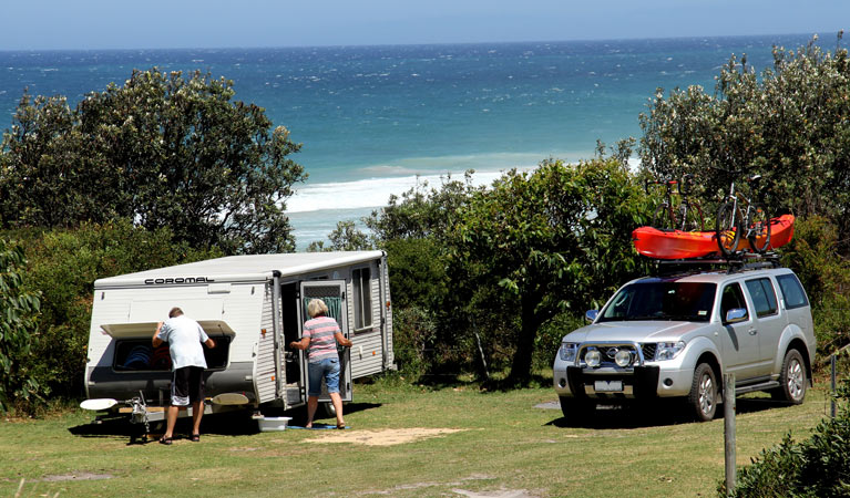 Campers with their camper trailer at Gillards campground, Mimosa Rocks National Park. Photo: John Yurasek/DPIE