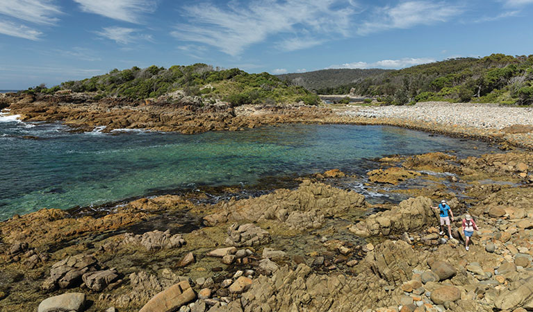 Visitors walking across the rocks on Mimosa Rocks walking track. Photo: David Finnegan &copy; OEH