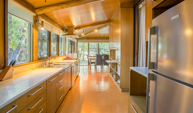 Photo of the long kitchen and dining table at Myer House. Photo: OEH/John Spencer