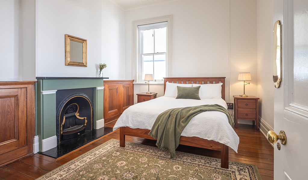 A bedroom with old fireplace in Montague Island Assistant Lighthouse Keeper's Cottage. Photo &copy; David Rogers/DPE