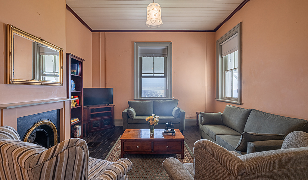 Lounge chairs and gas fire in the lounge room at Montague Island Assistant Lighthouse Keeper's Cottage. Photo &copy; David Rogers/DPE