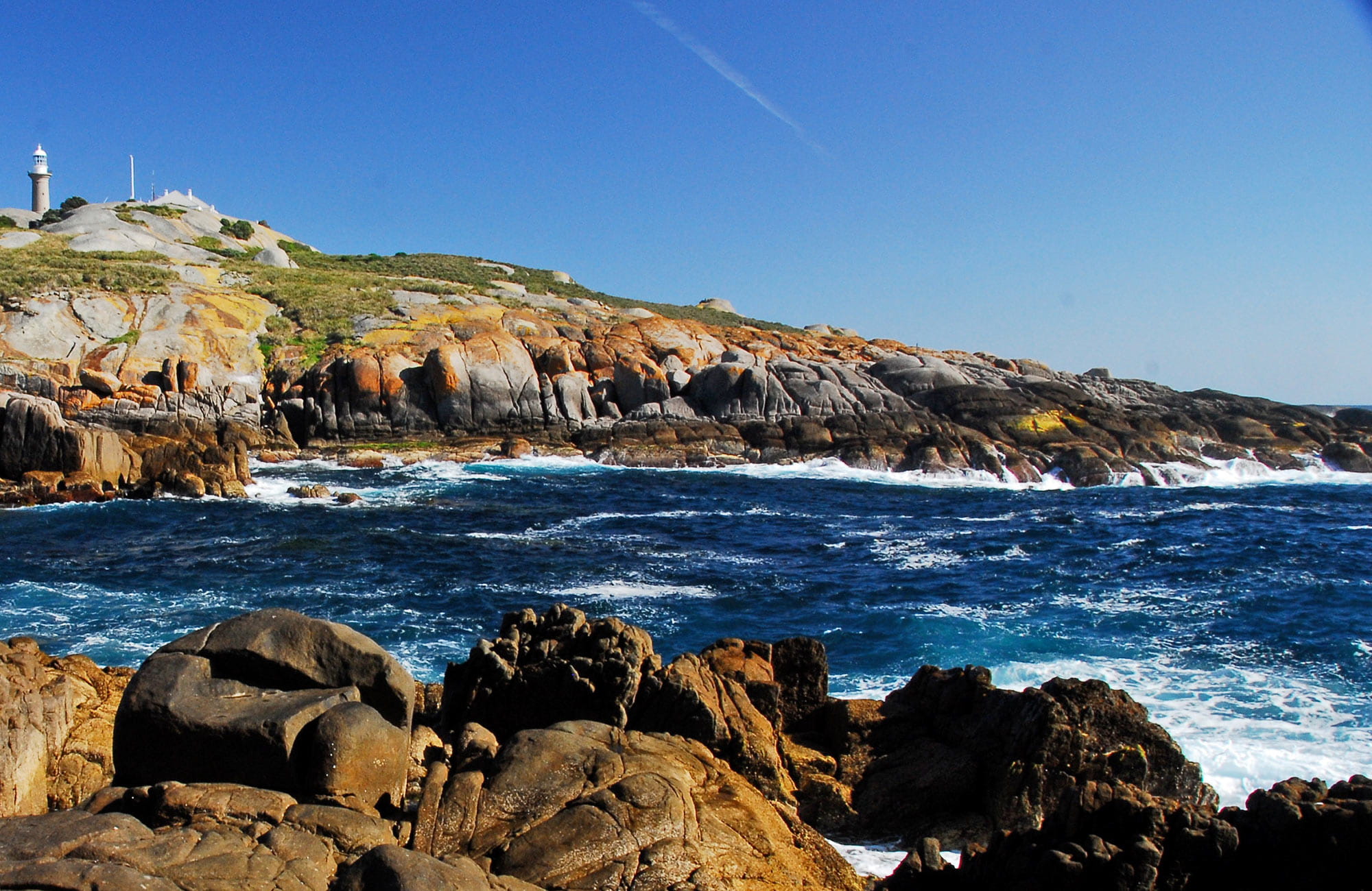View of Montague Island lighthouse from rocky coastline. Photo: Stuart Cohen/OEH
