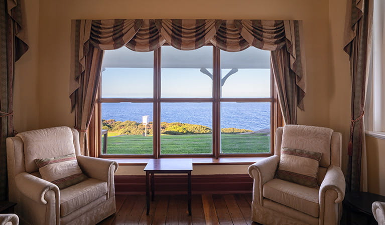 2 armchairs and window views from the lounge at Montague Island Lighthouse Keepers Cottage. Photo: Daniel Tran/OEH