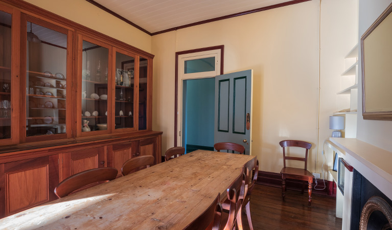 Dining table and cabinet in the dining room of Montague Island Head Lighthouse Keepers Cottage. Photo: Daniel Tran/OEH