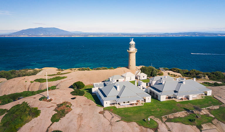 Aerial view of Montague Island Lighthouse and cottages, and views to the mainland. Photo: Daniel Tran/OEH