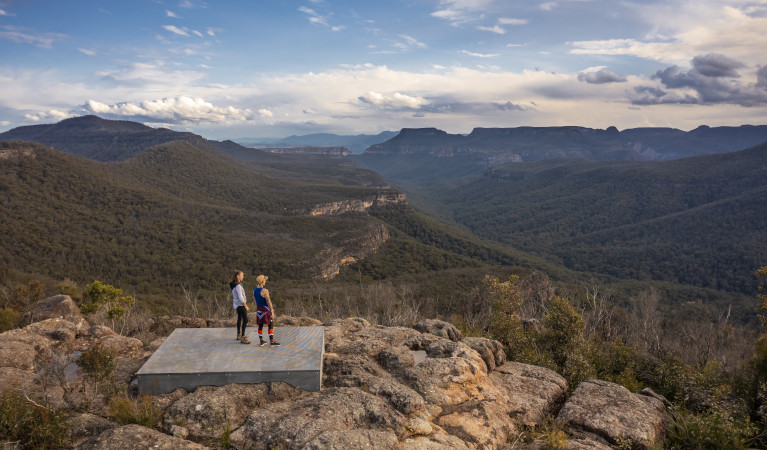 Two people standing on a viewing platform on Mount Bushwalker walking track in Morton National Park. Photo: John Spencer &copy; DPE