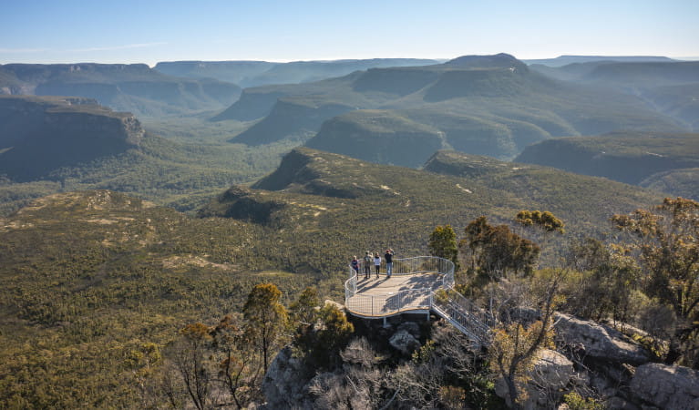 A group of people at a lookout on Pigeon House Mountain Didthul walking track. Mountains in background. Photo: John Spencer