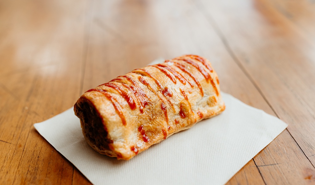 A tempting sausage roll drizzled with tomato sauce, The Burrow Cafe, Morton National Park. Credit and &copy;: Lily Crouch
