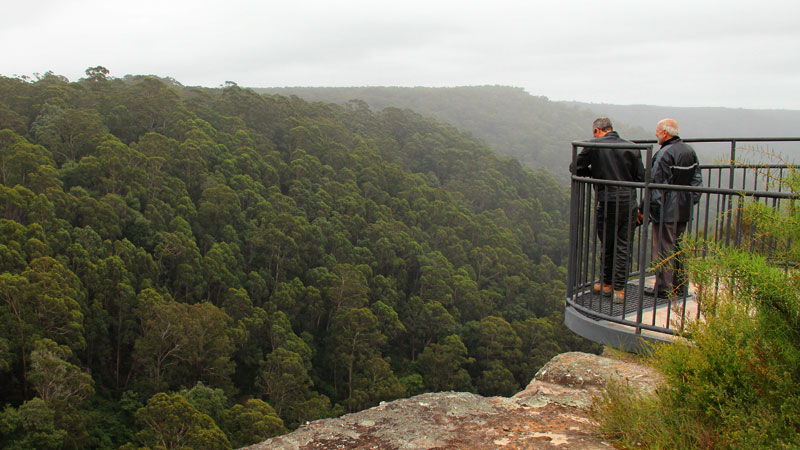 Two people at Tianjara Fall lookout. Photo: John Yurasek &copy; DPIE