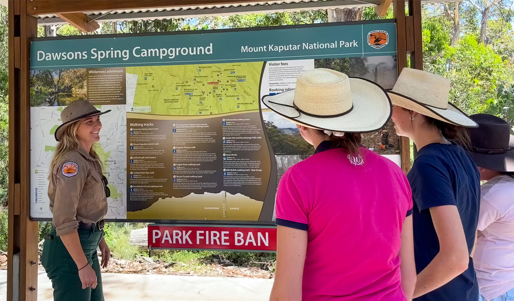 Ranger explains features of Dawsons Spring Nature Trail, Mount Kaputar National Park, to onlookers. Photo: Rochelle Eather, &copy; DCCEEW