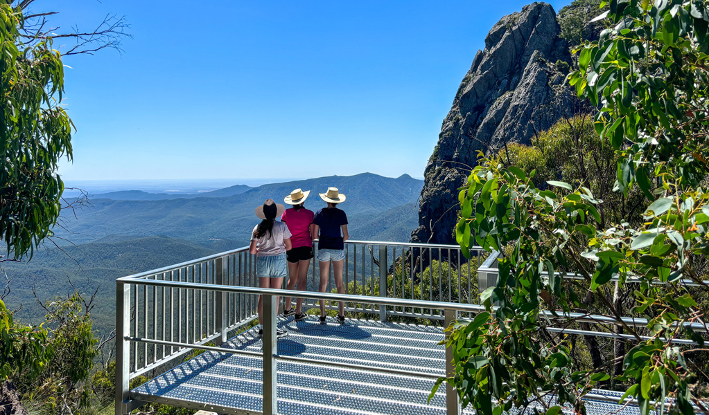 People admiring the view from West Kaputar Rock lookout, Mount Kaputar National Park. Photo: Louisa Anderson &copy; DCCEEW