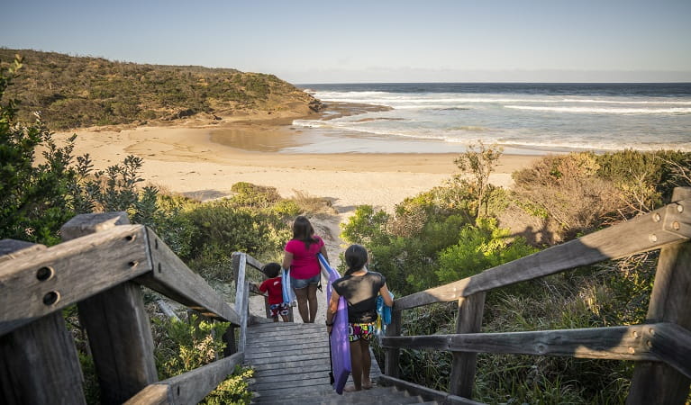 A family walking downstairs to Frazer beach, Munmorah State Conservation Area. Photo: John Spencer/OEH