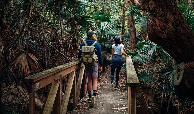A couple walk along Durras Lake discovery trail in Murramarang National Park. Photo: Melissa Findley/OEH.