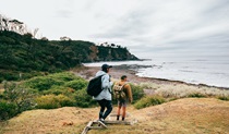 2 people walking towards Honeyscuckle Beach. Credit: <HTML>&copy;  Melissa Findley