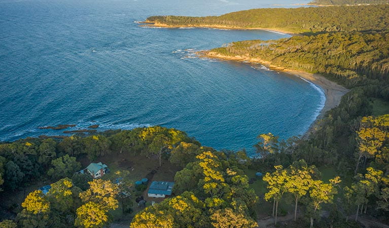 Aerial view of Judges House (right), neighbouring Yellow Rock Beach House and the coastline, Murramarang National Park. Photo: John Spencer &copy;DPIE