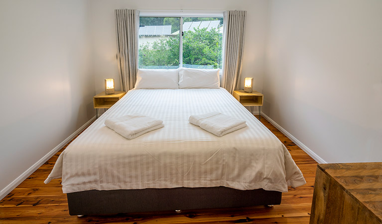 Judges House bedroom with queen bed and back wall window, Murramarang National Park. Photo: John Spencer &copy;DPIE