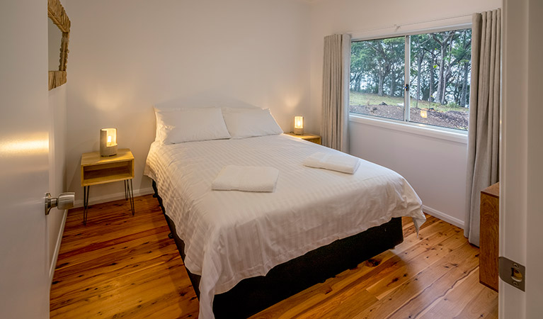 Judges House bedroom with queen bed and side wall window, Murramarang National Park. Photo: John Spencer &copy;DPIE