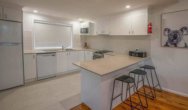 Judges House kitchen with modern appliances, bench and bar stools, Murramarang National Park. Photo: John Spencer &copy;DPIE