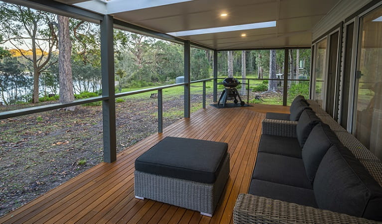 The covered verandah with lounge setting, barbecue and water views, Judges House, Murramarang National Park. Photo: John Spencer &copy;DPIE