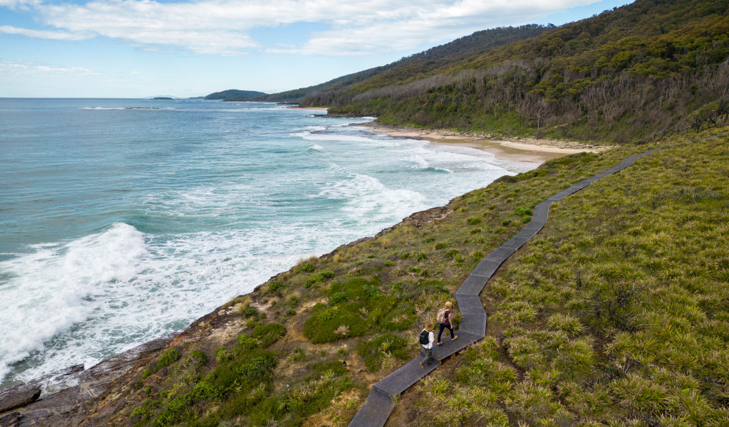 Aerial view of walkers on the formed walking track beside the ocean. Credit: John Spencer © DPE