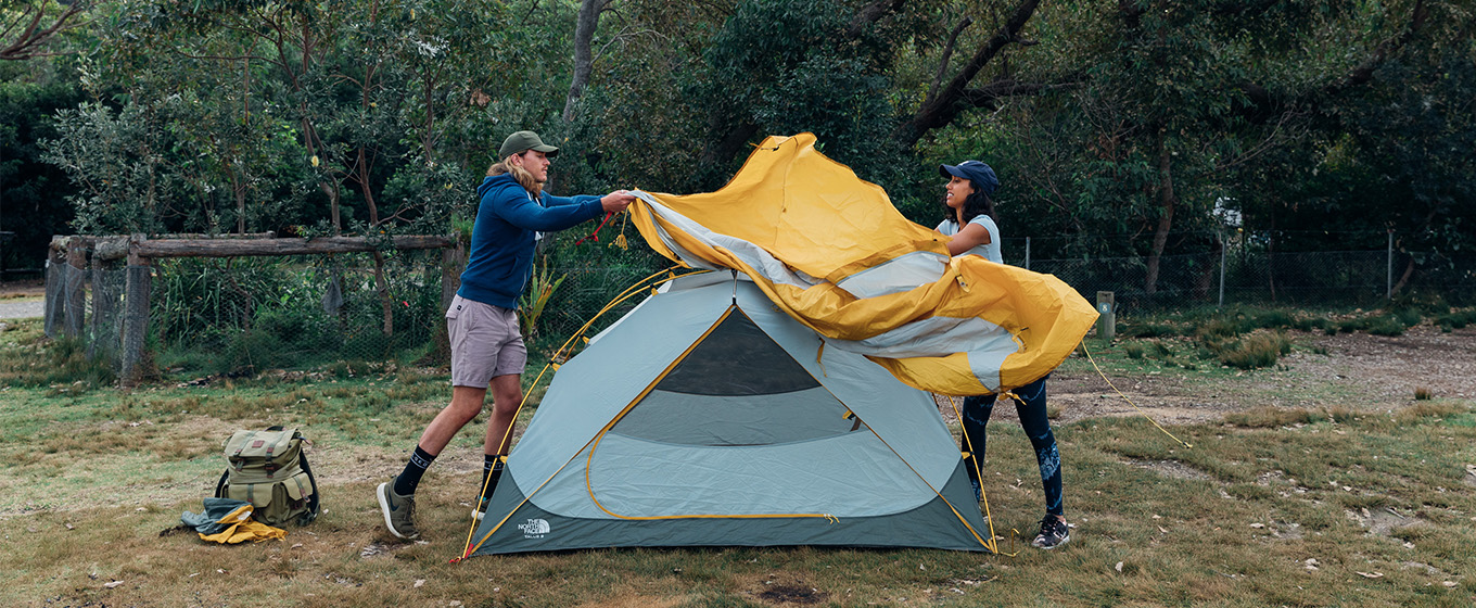 2 campers setting up their tent at Pretty Beach campground. Credit: Melissa Findley © Melissa Findley
