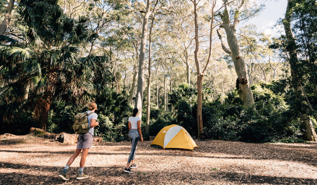 2 campers walking to their tent at Depot Beach campground. Credit: Melissa Findley © Melissa Findley