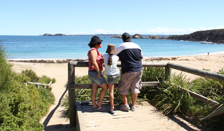 Family at a lookout over North Head Beach in Murramarang National Park. Photo: John Yurasek/DPIE