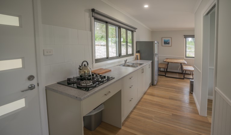 The kitchen and dining table at Pebbly Beach shacks in Murramarang National Park. Photo: John Spencer &copy; DPIE