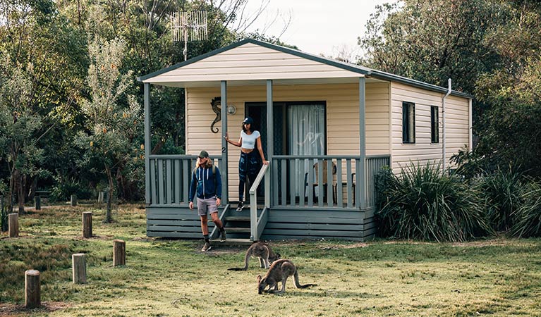 A couple at Pretty Beach cabins, Murramarang National Park. Photo: Melissa Findley/OEH.