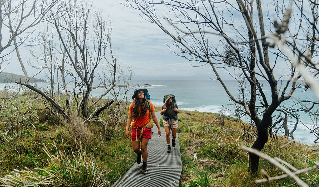 2 bushwalkers following Pretty Beach to Pebbly Beach walking track across the headland, Murramarang National Park. Credit: Remy Brand &copy; Remy Brand