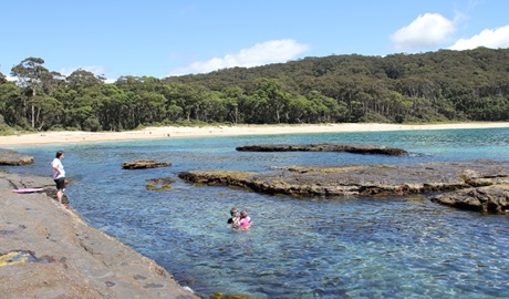 Family snorkelling near a rock platform at Depot Beach, located in Murramarang National Park. Photo: John Yurasek &copy; OEH