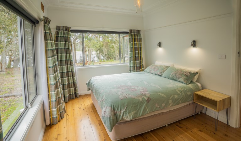 A bedroom with views out to the surrounding bush at Yellow Rock Beach House in Murramarang National Park. Photo: John Spencer &copy; DPIE