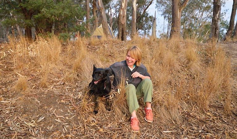 Camper with her dog in Murray Valley Regional Park. Photo: Gavin Hansford/NSW Government