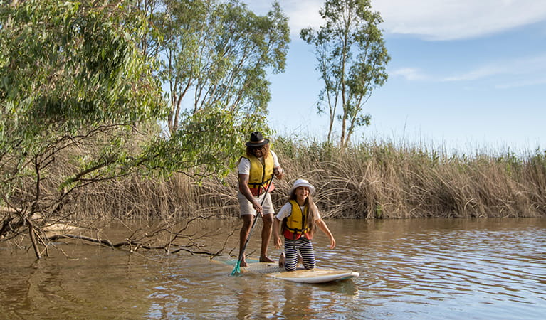 Dad and daughter share a stand up paddleboard on the Murray River. Photo: B Ferguson/OEH
