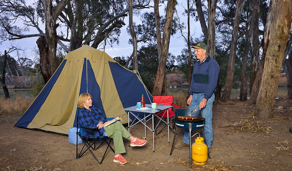 Campers barbecuing outside their tent at Millewa campgrounds in Murray Valley Regional Park.  Photo: Gavin Hansford &copy; OEH