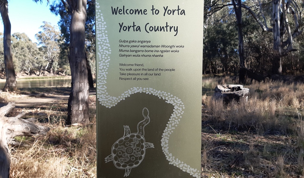 A sign welcoming walkers to Yorta Yorta Country, with gum trees in the background, Murray Valley Regional Park. Credit: Michael Murphy/DCCEEW &copy; DCCEEW
