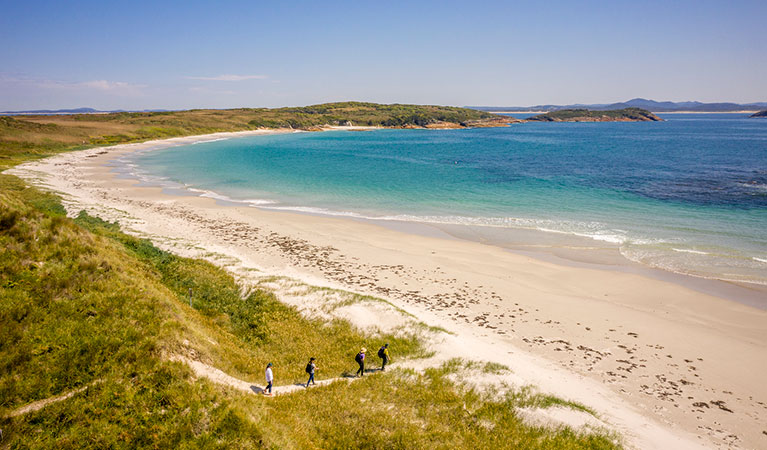 Aerial view of 4 people on a walking track on Broughton Island, Myall Lakes National Park. Photo: John Spencer &copy; DPIE