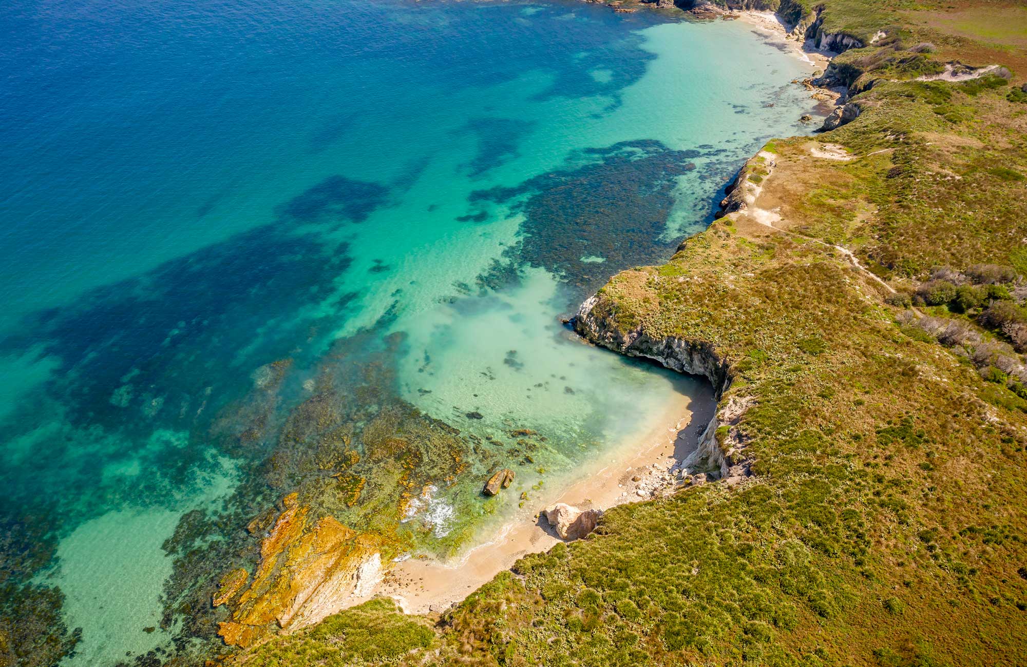 Aerial view over Coal Shaft Bay lookout showing cliffs, rocky headland, beaches and reefs on Broughton Island, Myall Lakes National Park. Photo: John Spencer &copy DPIE