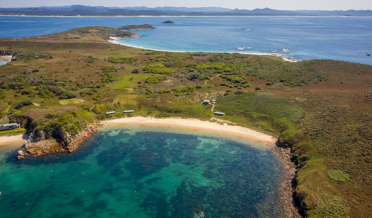 An aerial view of Broughton Island campground and nearby beach in Myall Lakes National Park. Photo: John Spencer &copy; DPIE